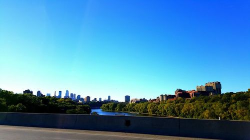 View of buildings against clear blue sky