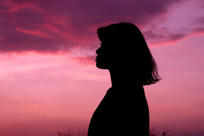 Silhouette woman against sky during sunset