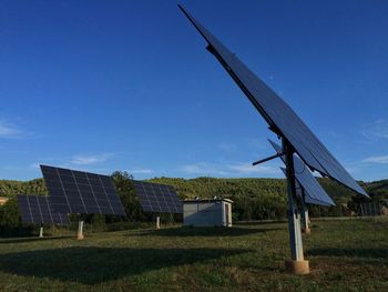 Wind turbines on grassy field