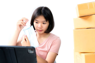 Portrait of woman holding mobile phone