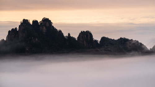 Scenic view of rock formation against sky during sunset