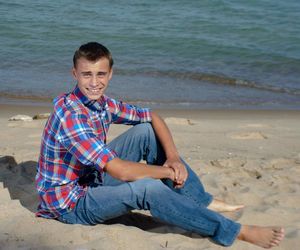 Portrait of young man sitting on beach