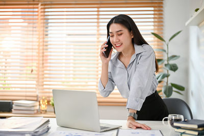 Businesswoman talking on phone in office