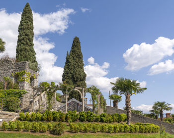 Trees in front of temple against sky