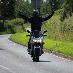 Rear view of man riding motorcycle