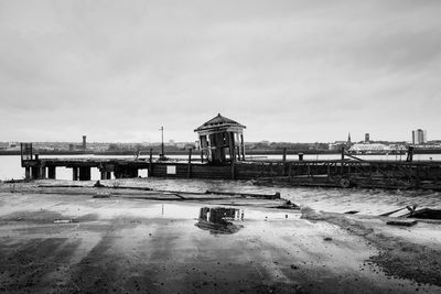 Abandoned built structure on broken pier against sky