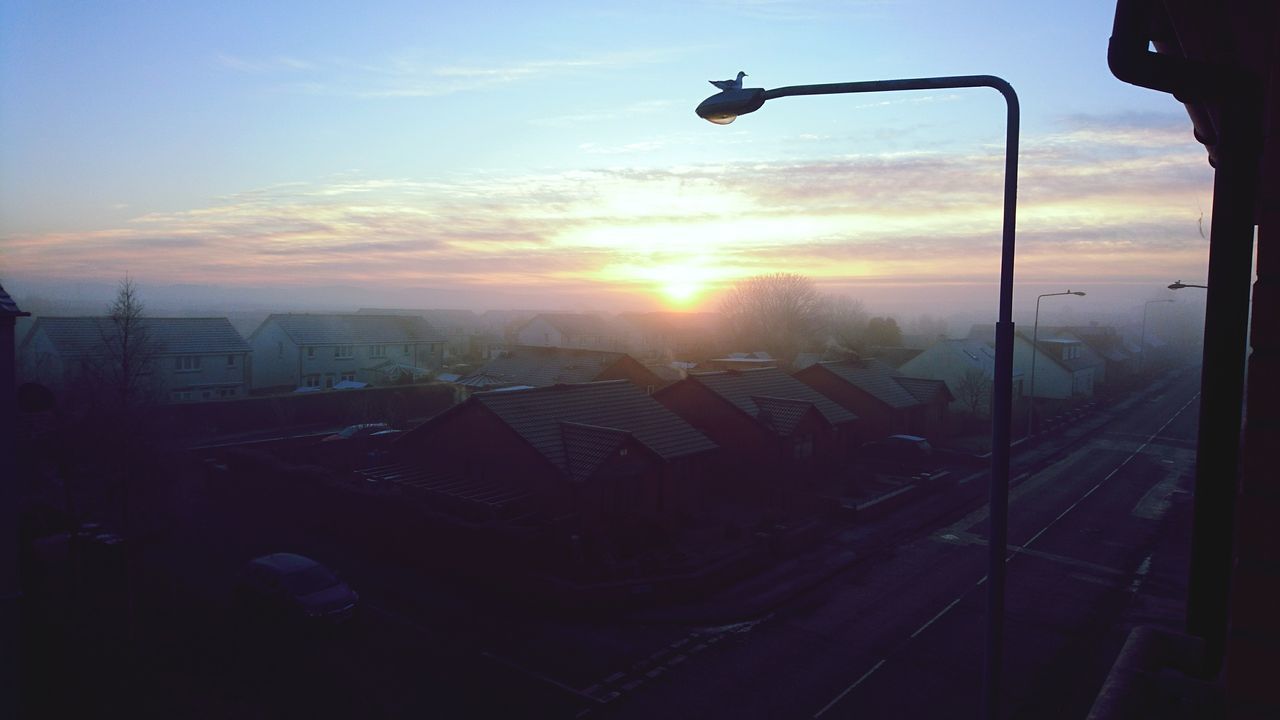 SILHOUETTE OF CITY STREET AGAINST SKY