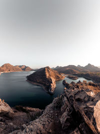 Scenic view of lake and mountains against clear sky udaipur india 