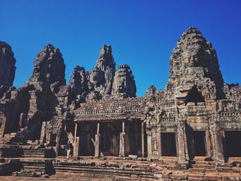 Low angle view of temple against clear blue sky