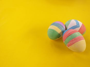 Close-up of multi colored pencils on yellow background