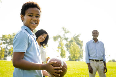 Portrait of smiling couple standing on field