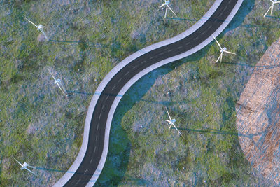 High angle view of road amidst trees on field