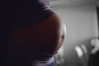 Close-up of pregnant woman at home