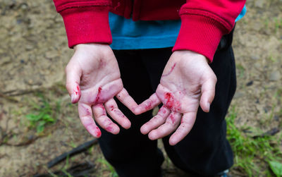 Low section of woman holding pink hands