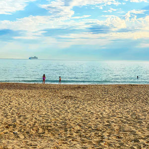 People on beach against sky