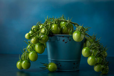 Close-up of grapes in glass container on table