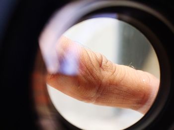 Cropped hand seen through circular shape window