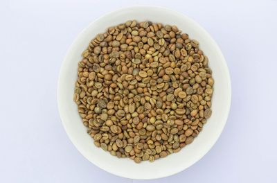 Directly above shot of bread in bowl against white background