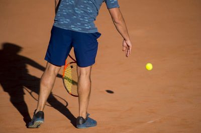 Low section of man playing tennis