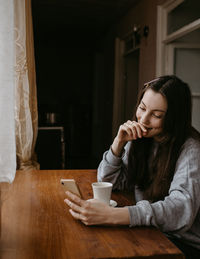 Young woman sitting on table