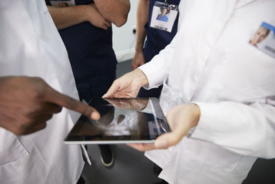 Healthcare workers discussing on tablet pc at hospital