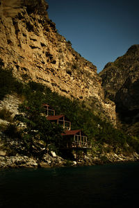 Scenic view of house and mountain against sky