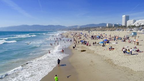 People on beach against sky