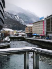 Close-up of snow on bridge against sky