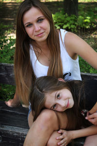 Portrait of smiling girl sitting outdoors