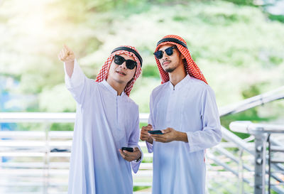 Business colleagues wearing traditional clothing while standing outdoors