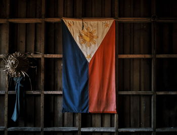 Philippines flag hanging from wooden wall