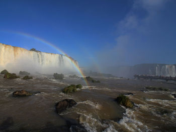 Scenic view of waterfall in iguazu falls against sky