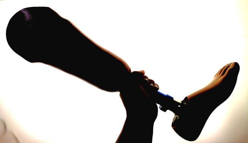 Close-up of silhouette hand against white background