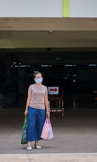 Full length of woman walking with umbrella