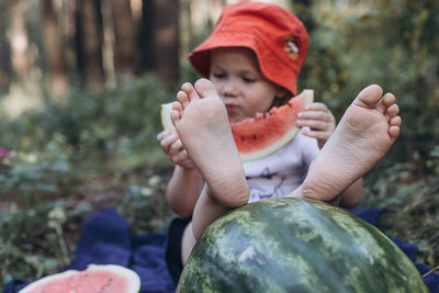 Cute girl eating watermelon outdoors