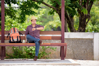 Man sitting on tree trunk