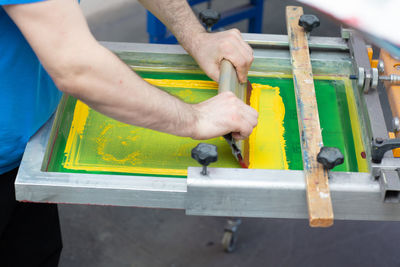 Midsection of man working on wood