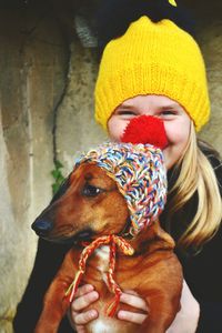 Portrait of smiling girl with dog outdoors