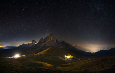 Scenic view of mountains against sky at night