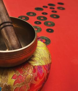 High angle view of mortar and pestle against red background