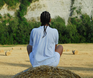 Rear view of woman standing on field