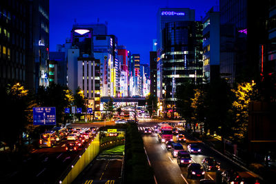 Vehicles on road in city at night