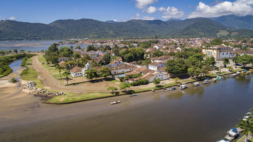 High angle view of townscape by sea against sky