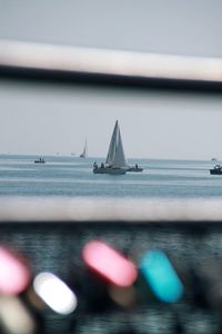 Sailboat sailing on sea against sky