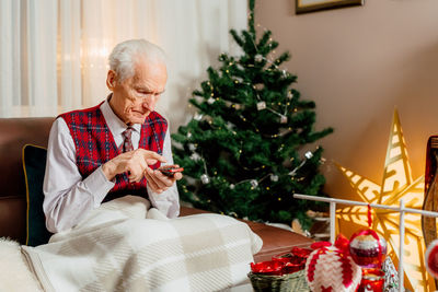 Portrait of senior man with christmas decoration