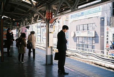 People waiting at railroad station platform