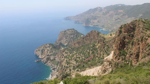 High angle view of sea and mountains against clear sky