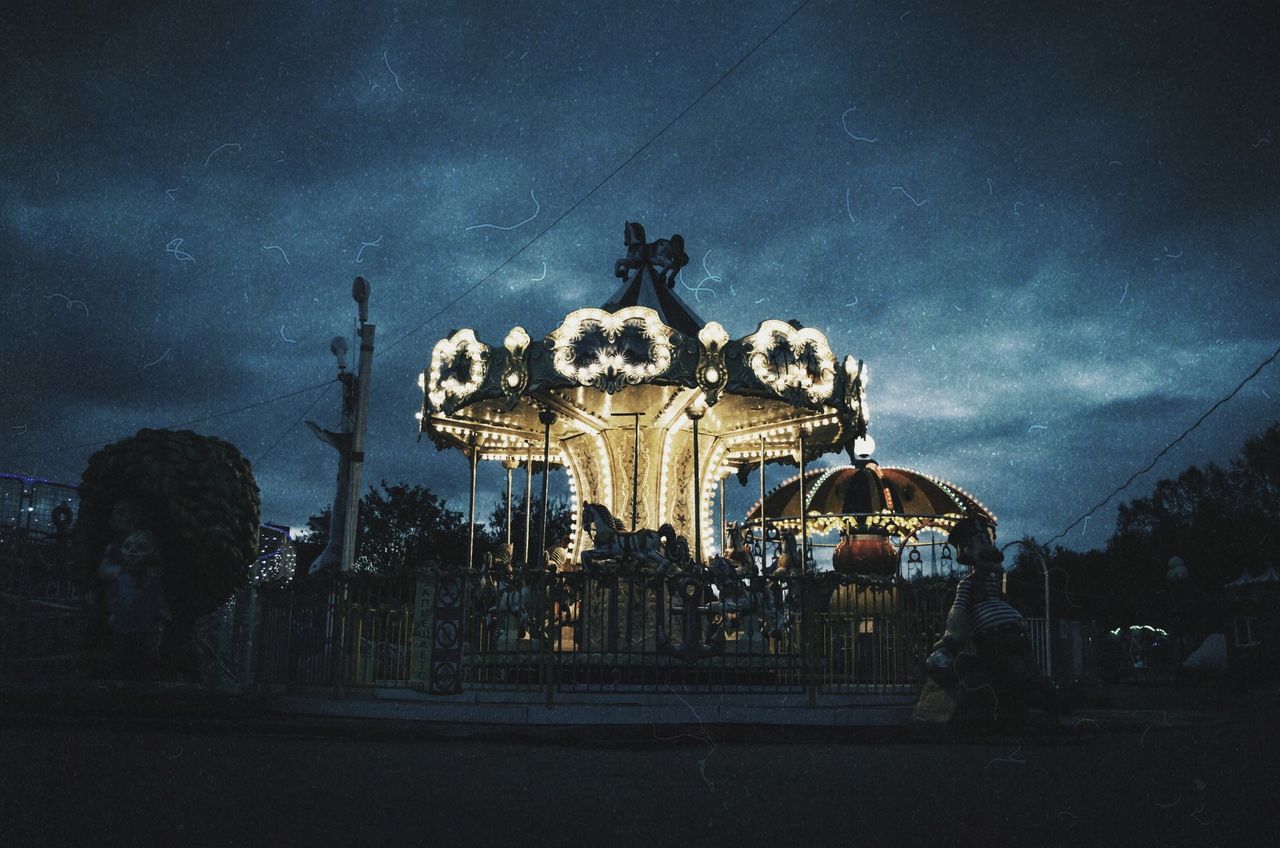 arts culture and entertainment, architecture, sky, amusement park, amusement park ride, art and craft, representation, animal representation, built structure, carousel, cloud - sky, night, illuminated, nature, building exterior, no people, dusk, outdoors, city