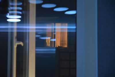 Illuminated lights seen through glass window at night