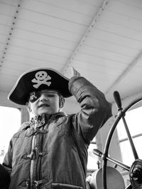 Portrait of boy against boat on wall during halloween